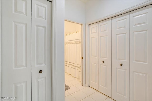 corridor featuring light tile patterned flooring