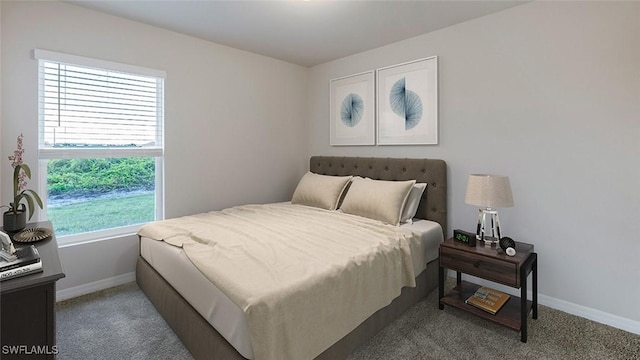 carpeted bedroom featuring baseboards