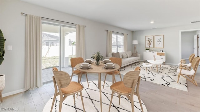 dining space with light wood-style flooring, baseboards, visible vents, and recessed lighting