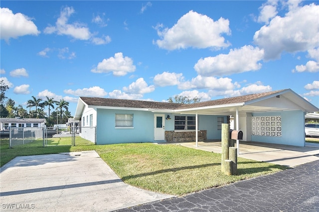 8150 Cleaves Rd, North Fort Myers, FL 33903 - view of front facade with a carport, a gate, driveway, a front lawn, and fence