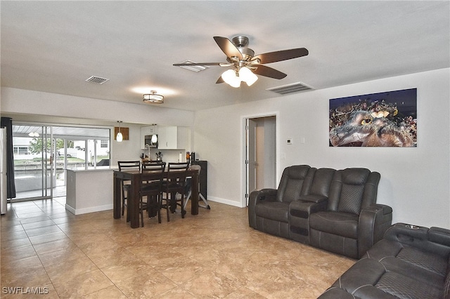 8150 Cleaves Rd, North Fort Myers, FL 33903 - living area with light tile patterned floors, visible vents, baseboards, and a ceiling fan