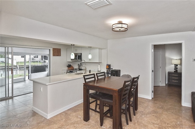8150 Cleaves Rd, North Fort Myers, FL 33903 - dining space featuring light tile patterned floors, visible vents, and baseboards