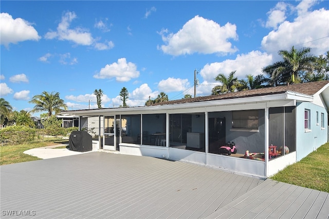 8150 Cleaves Rd, North Fort Myers, FL 33903 - back of property featuring a sunroom and a deck