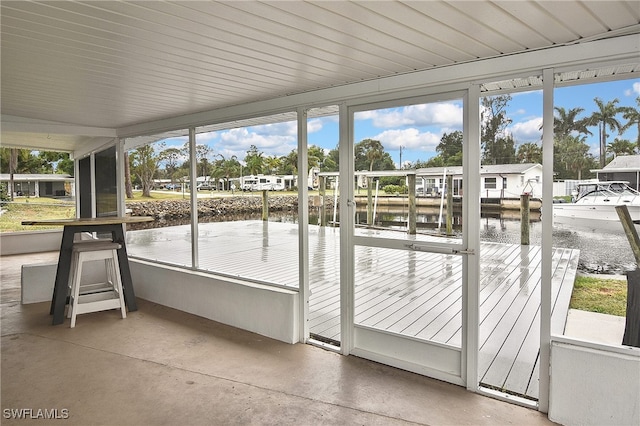 8150 Cleaves Rd, North Fort Myers, FL 33903 - unfurnished sunroom with a water view, concrete floors, and a healthy amount of sunlight