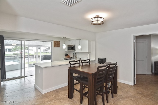 8150 Cleaves Rd, North Fort Myers, FL 33903 - dining room featuring light tile patterned floors, visible vents, and baseboards