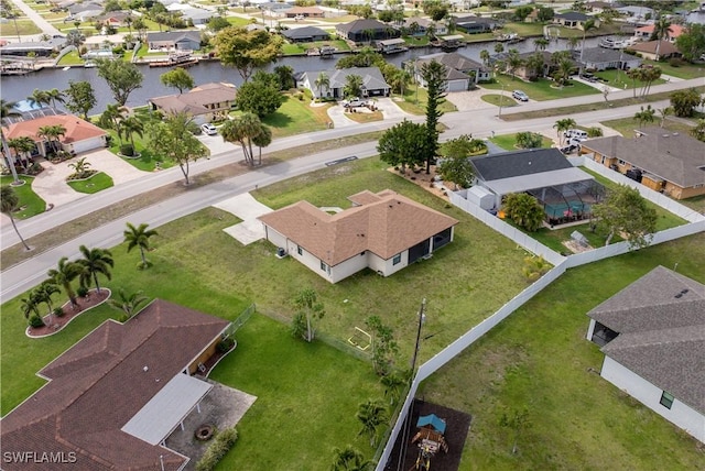 birds eye view of property featuring a water view and a residential view