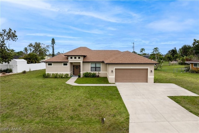 view of front of property featuring a front yard, an attached garage, fence, stucco siding, and driveway
