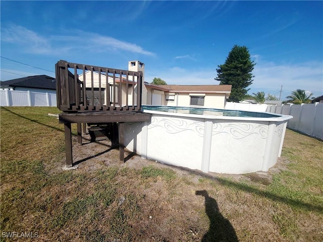 back of house with a fenced in pool, a yard, stucco siding, and fence