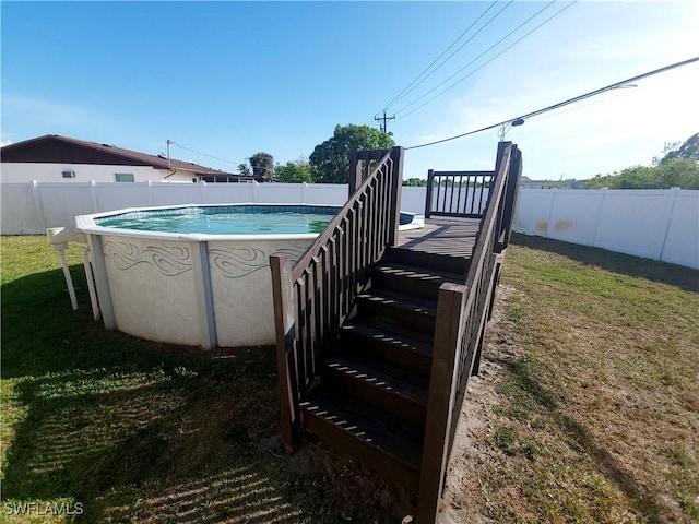 view of swimming pool featuring a fenced backyard, a fenced in pool, and a lawn