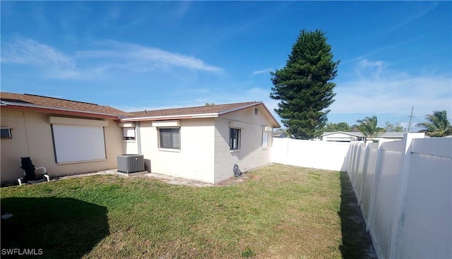 view of home's exterior with a fenced backyard and a lawn