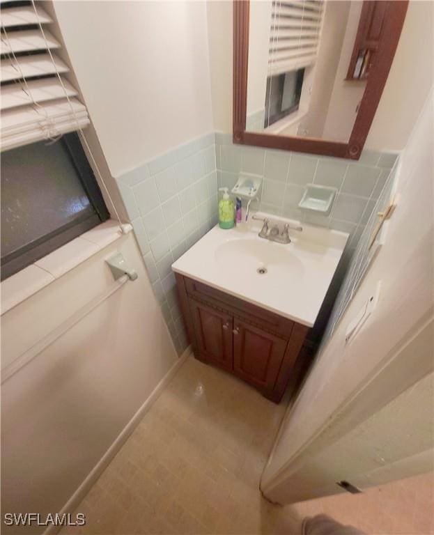 bathroom featuring vanity, tile walls, and a wainscoted wall