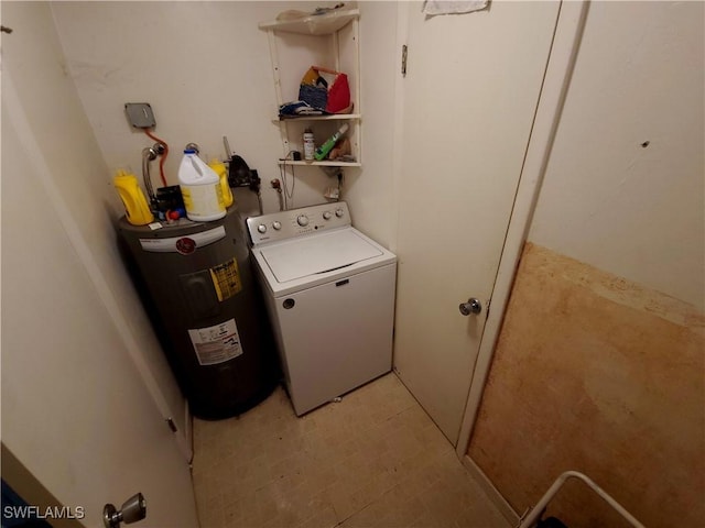laundry room featuring water heater, washer / dryer, and laundry area