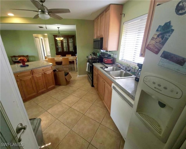 kitchen featuring light tile patterned floors, a sink, light countertops, ceiling fan, and white appliances