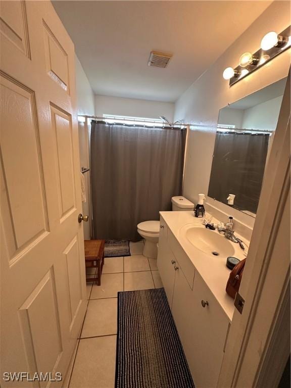 bathroom featuring vanity, curtained shower, tile patterned flooring, toilet, and visible vents