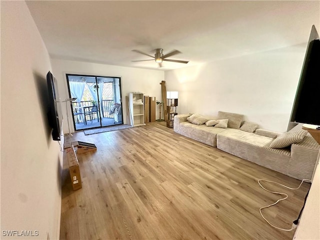 living area featuring a ceiling fan and light wood-style flooring