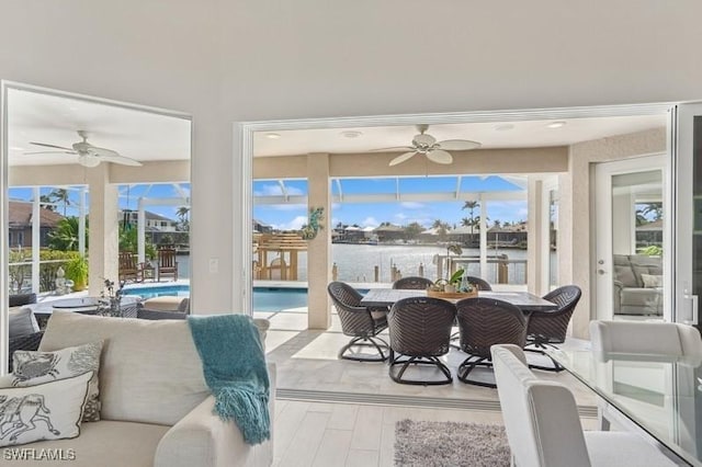 sunroom / solarium with a water view