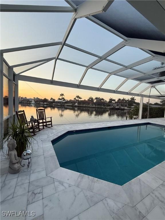 61 N Barfield Dr, Marco Island, FL 34145 - outdoor pool with a water view, glass enclosure, and a patio