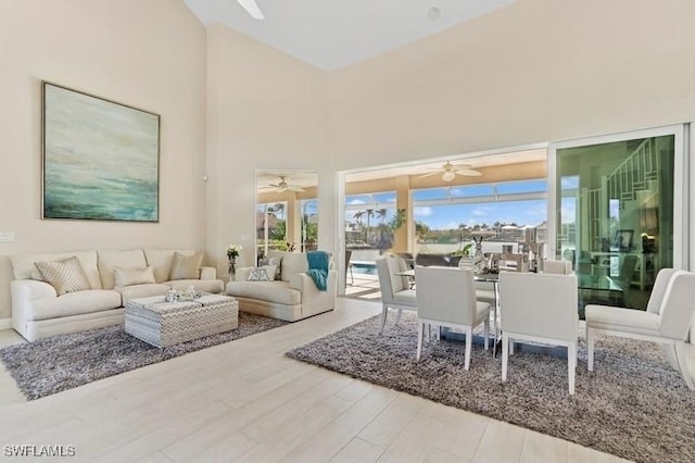 61 N Barfield Dr, Marco Island, FL 34145 - living room with ceiling fan, a towering ceiling, and wood finished floors