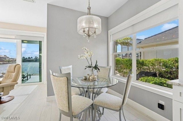 61 N Barfield Dr, Marco Island, FL 34145 - dining space with plenty of natural light, a chandelier, and baseboards