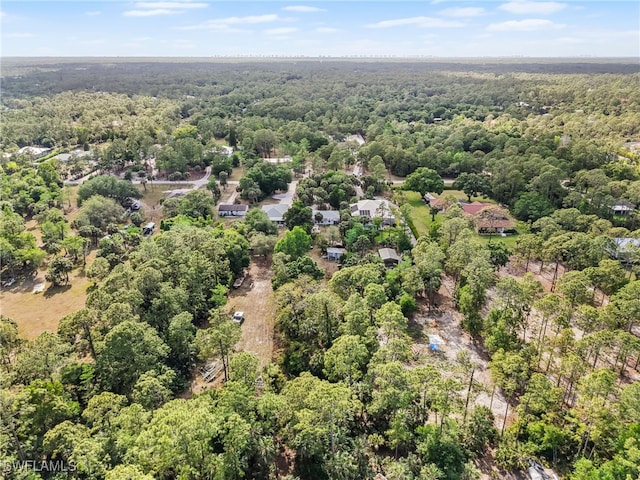 drone / aerial view featuring a forest view