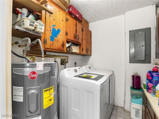 clothes washing area featuring a textured ceiling, electric panel, water heater, washer and dryer, and cabinet space