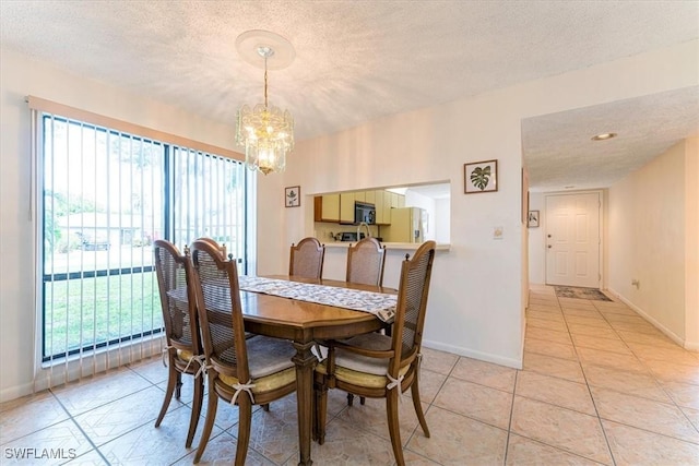 232 Pebble Beach Cir Unit E104, Naples, FL 34113 - dining area with a chandelier, plenty of natural light, baseboards, and a textured ceiling