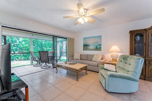 232 Pebble Beach Cir Unit E104, Naples, FL 34113 - living area featuring a textured ceiling, ceiling fan, and light tile patterned floors