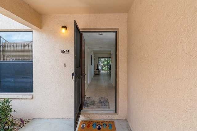 232 Pebble Beach Cir Unit E104, Naples, FL 34113 - doorway to property featuring stucco siding