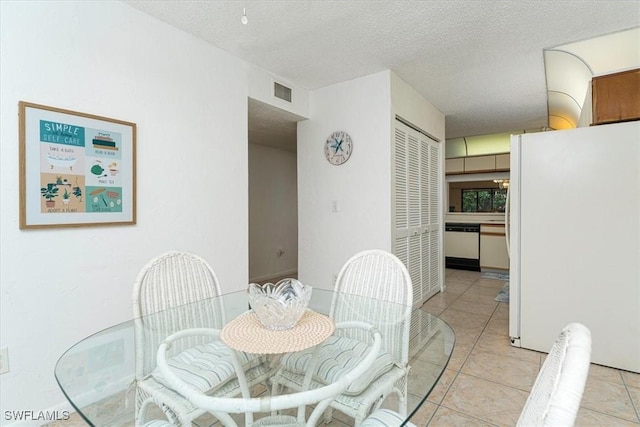 232 Pebble Beach Cir Unit E104, Naples, FL 34113 - tiled dining space with a textured ceiling