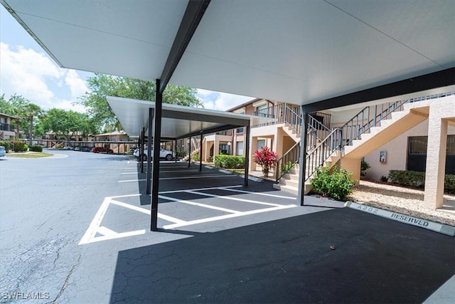 232 Pebble Beach Cir Unit E104, Naples, FL 34113 - covered parking lot with stairway