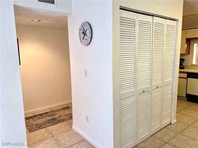 232 Pebble Beach Cir Unit E104, Naples, FL 34113 - hallway with light tile patterned floors and a textured ceiling