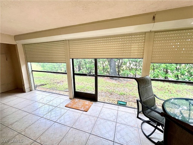 232 Pebble Beach Cir Unit E104, Naples, FL 34113 - sunroom with a textured ceiling