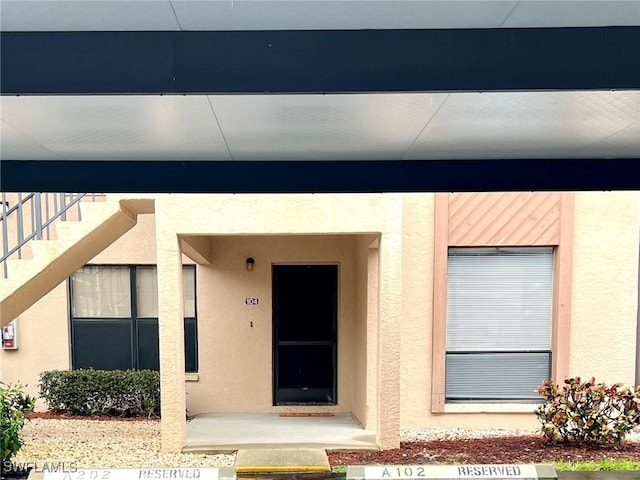 232 Pebble Beach Cir Unit E104, Naples, FL 34113 - view of exterior entry featuring stucco siding