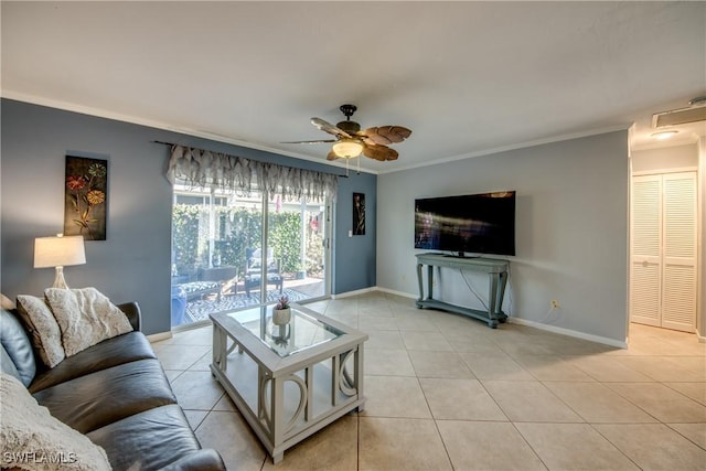 living area with ornamental molding, baseboards, a ceiling fan, and light tile patterned flooring
