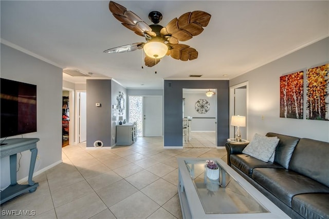 living room featuring crown molding, ceiling fan, visible vents, light tile patterned flooring, and baseboards