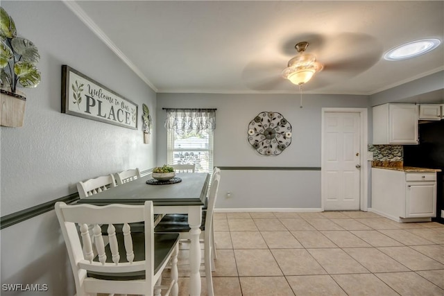 dining space featuring ornamental molding, baseboards, a ceiling fan, and light tile patterned flooring