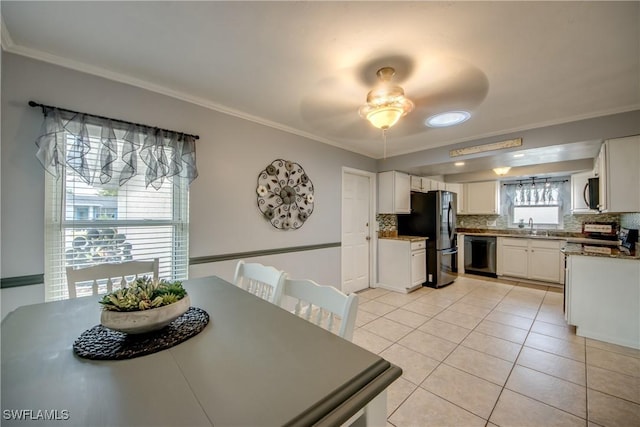 dining room featuring light tile patterned floors, ornamental molding, and a ceiling fan