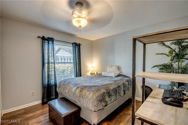 bedroom with a ceiling fan, baseboards, and dark wood-style floors