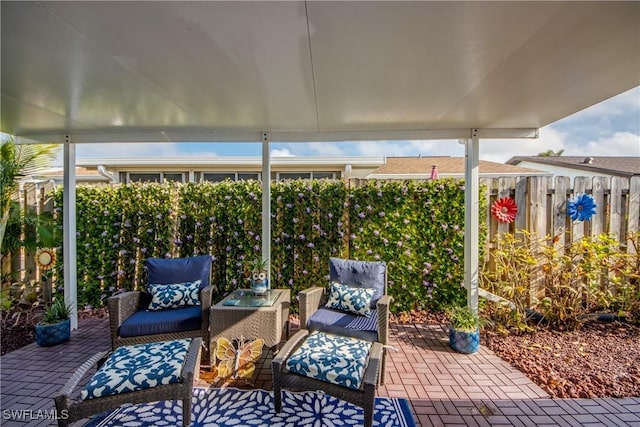 view of patio / terrace featuring an outdoor living space and fence