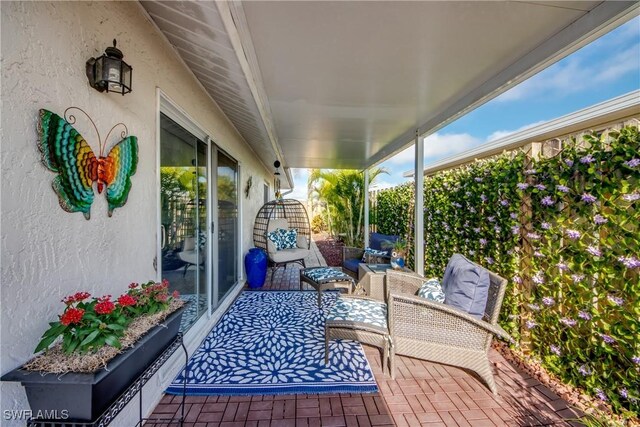 view of patio featuring outdoor lounge area and fence