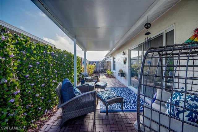 view of patio / terrace with an outdoor living space and fence