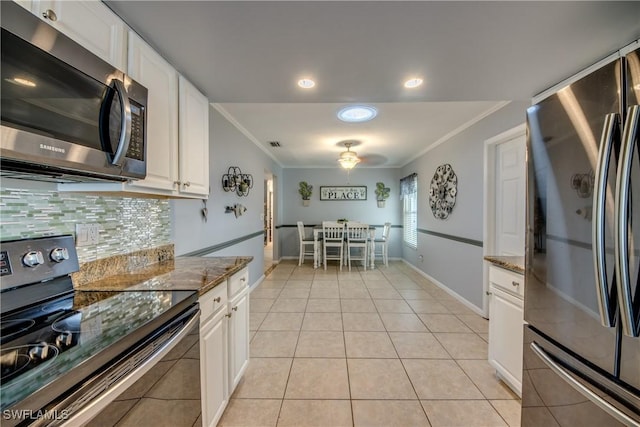 kitchen with stone counters, ornamental molding, and appliances with stainless steel finishes
