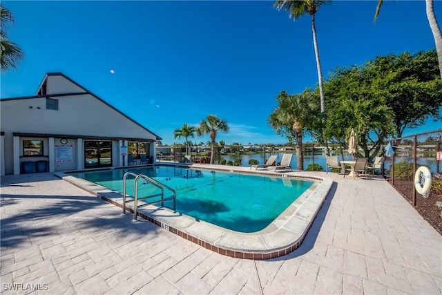 community pool featuring a patio area and a water view