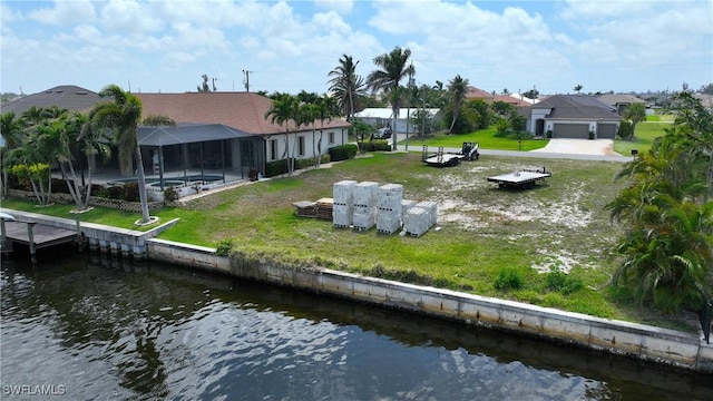 3309 NW 3rd Ter, Cape Coral, FL 33993 - back of house featuring a water view, an outdoor pool, a lanai, and a yard