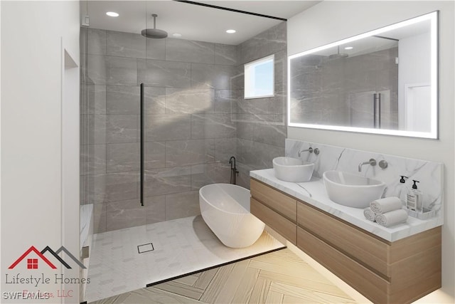3309 NW 3rd Ter, Cape Coral, FL 33993 - bathroom with walk in shower, a freestanding tub, double vanity, recessed lighting, and tile walls