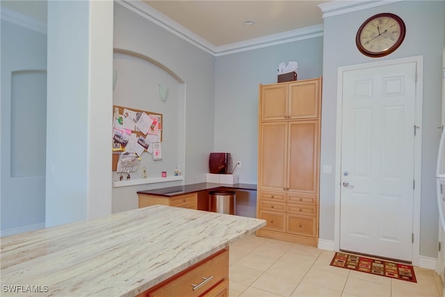 2042 Mandarin Ln, Naples, FL 34120 - kitchen with light tile patterned floors, crown molding, light brown cabinets, and light stone counters