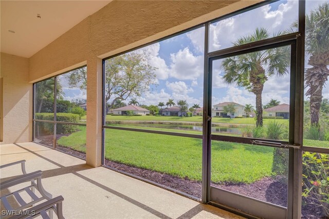2042 Mandarin Ln, Naples, FL 34120 - unfurnished sunroom with a water view, a residential view, and lofted ceiling