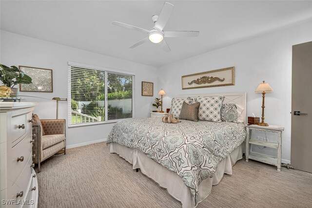bedroom featuring baseboards, ceiling fan, and light carpet