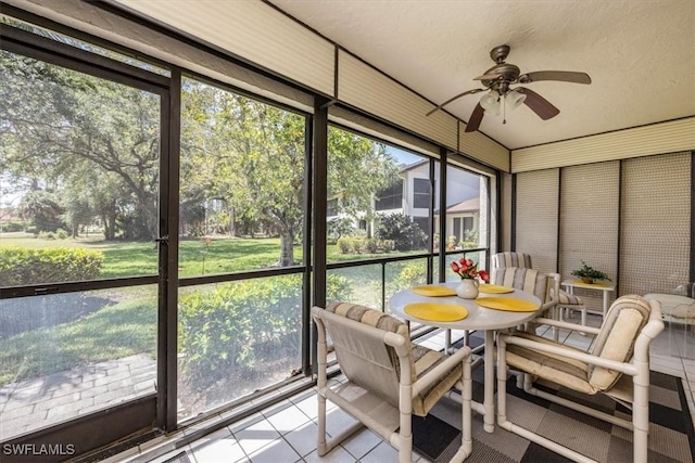 sunroom featuring ceiling fan