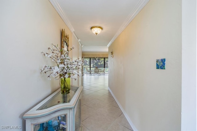 hall with baseboards, ornamental molding, and light tile patterned flooring